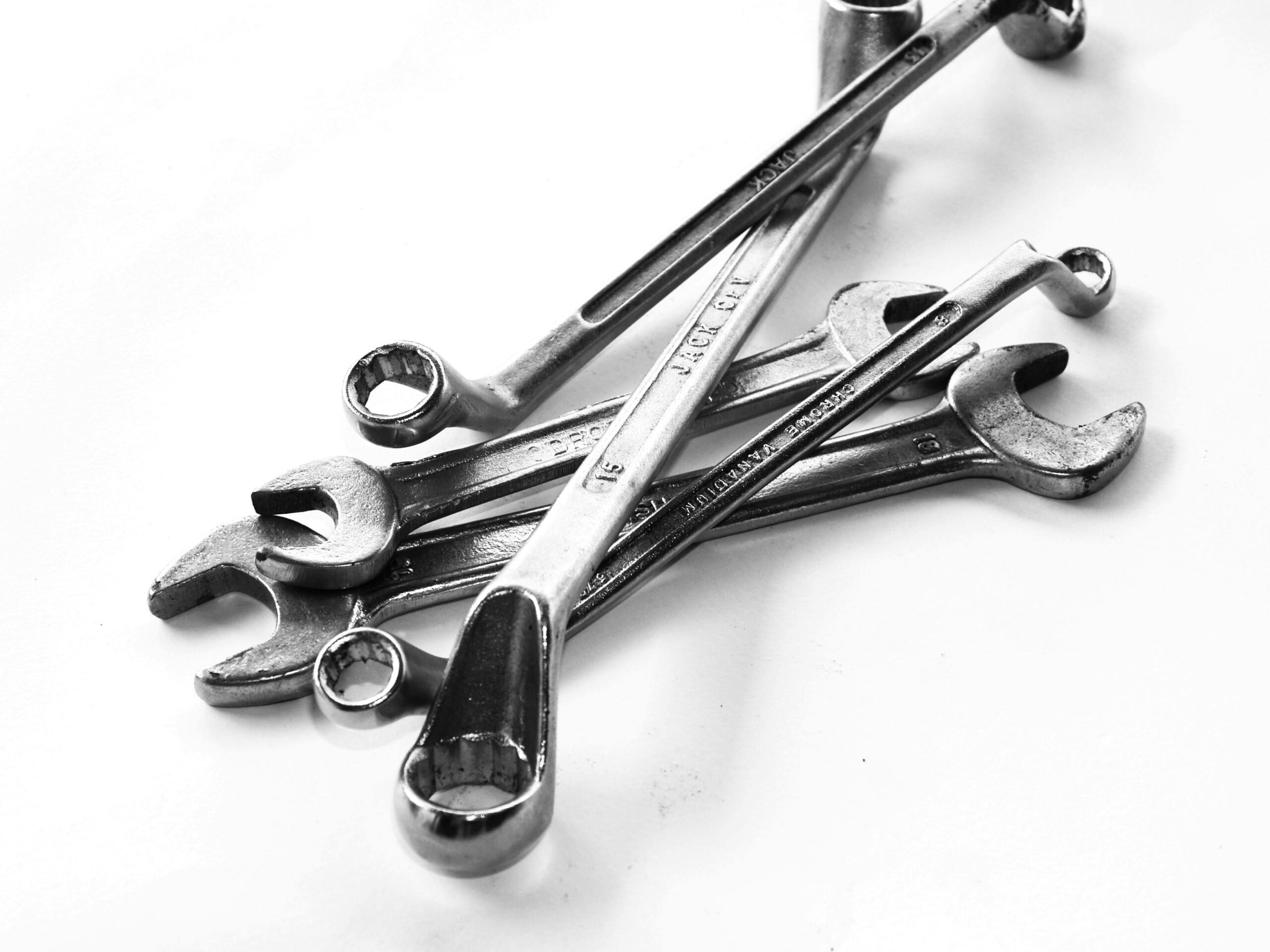 A collection of steel wrenches displayed against a white backdrop, perfect for toolkits.